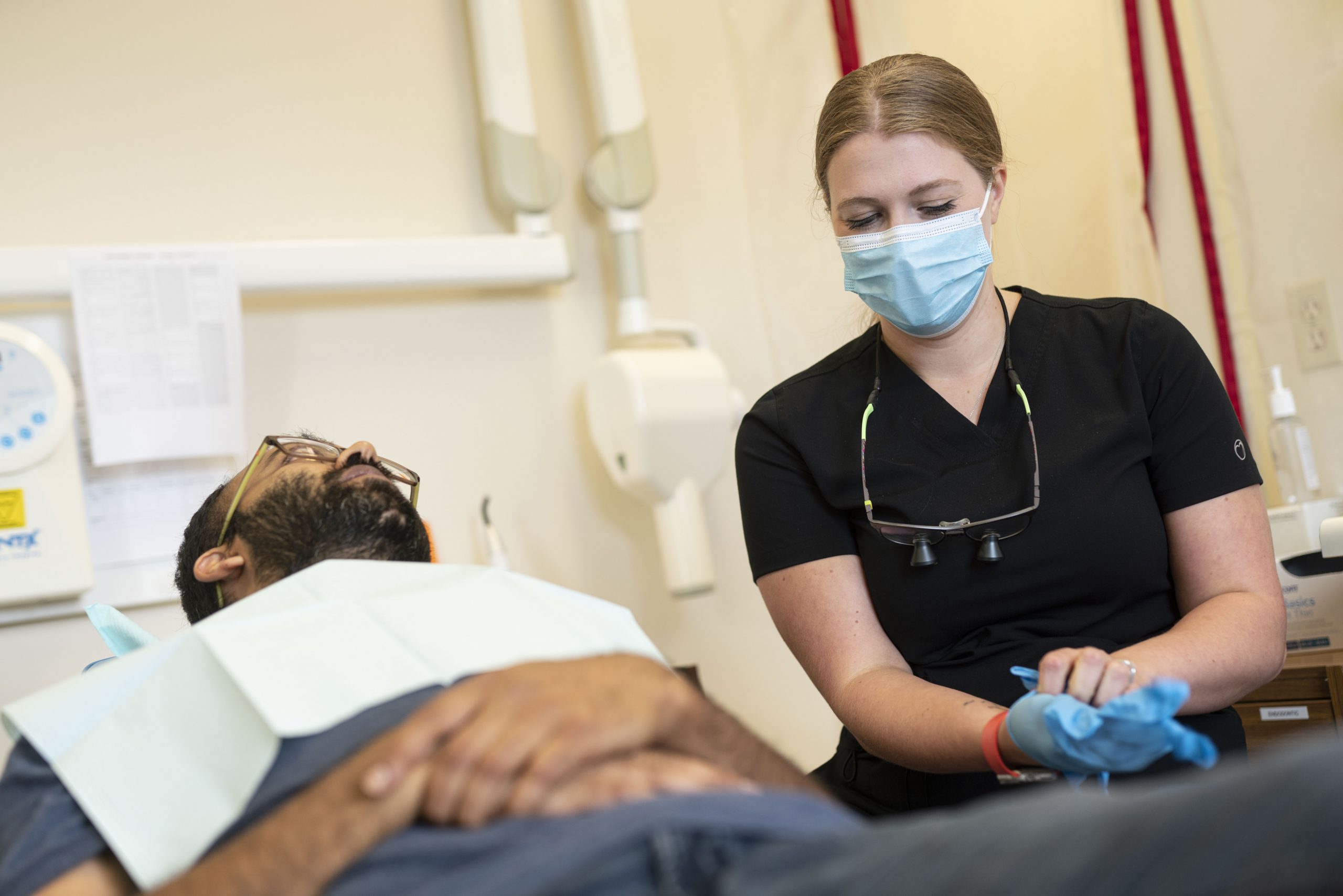 Dr. Sekhon treating a patient in Ottawa at her dental office on Carling