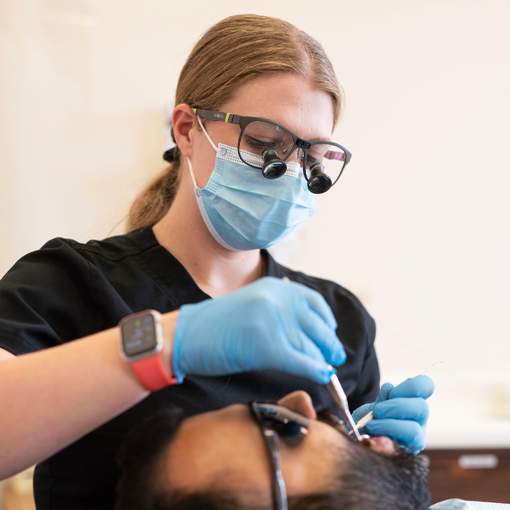 dental-implant-2 dental hygienist preparing a patient for a dental implant procedure
