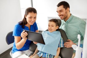 son and father being shown tooth xrays by doctor