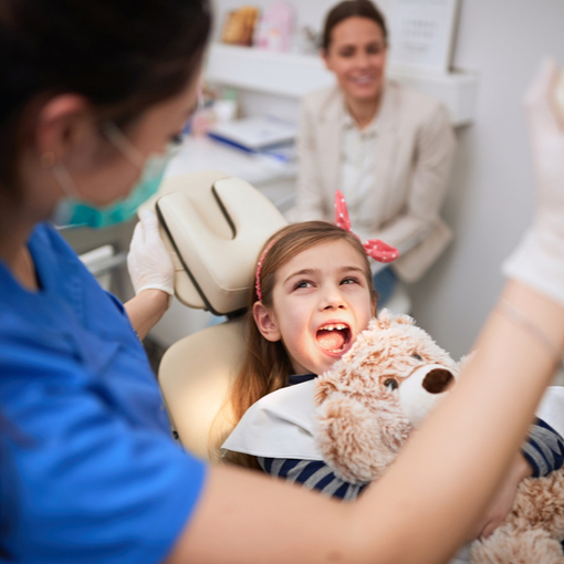 Dr. Sekhon treating a patient in Ottawa at her dental office on Carling