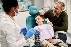father and son in a dental check-up for son