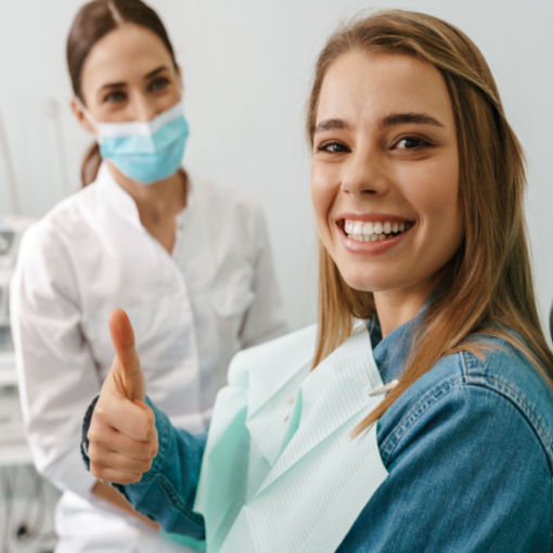 Shutterstock_1938573148 woman placing her Invisalign trays on her teeth