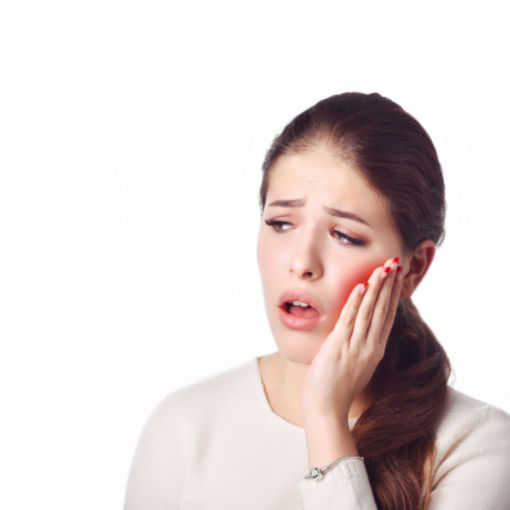 Shutterstock_781524841 woman placing her Invisalign trays on her teeth