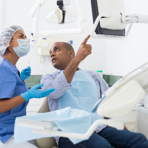 Dental Implant Consultation Dental Implant Consultation with a dentist and patient in a dental office