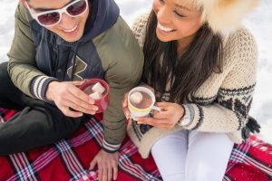 couple drinking hot cocoa in the winter