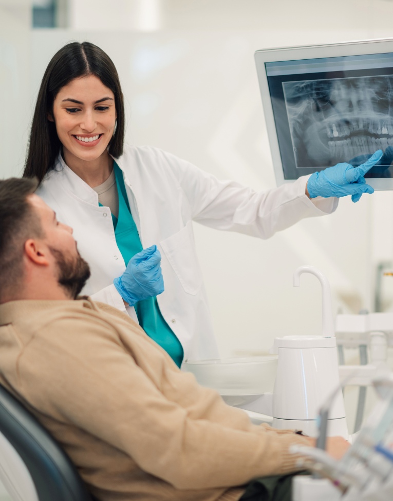 woman placing her Invisalign trays on her teeth