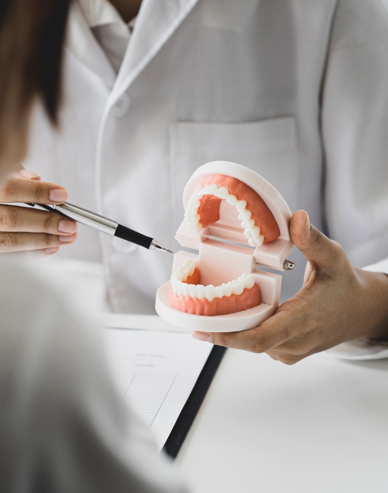 Man Holding Up Two Trays of Invisalign 