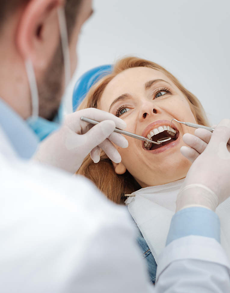 young woman being serious about her health and paying a regular visit to her dentist while sitting in a special chair